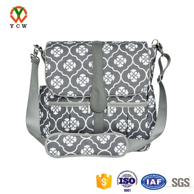 Spacious interior crib diaper bag with exterior bottle pockets